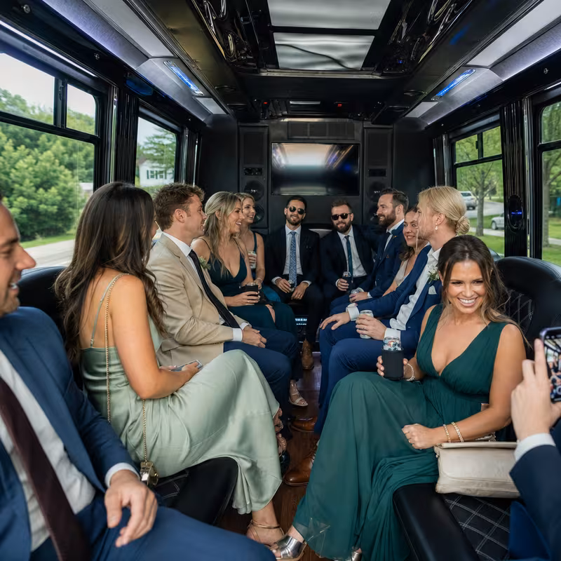 Wedding guests seated inside a Seattle party bus