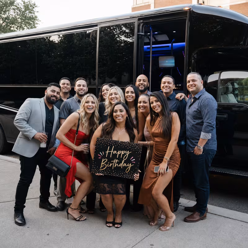 Group boarding a white charter bus for Birthday Transportation transportation in Seattle