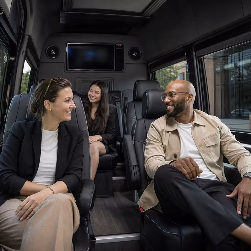 Group boarding a white charter bus for Corporate Transportation transportation in Seattle