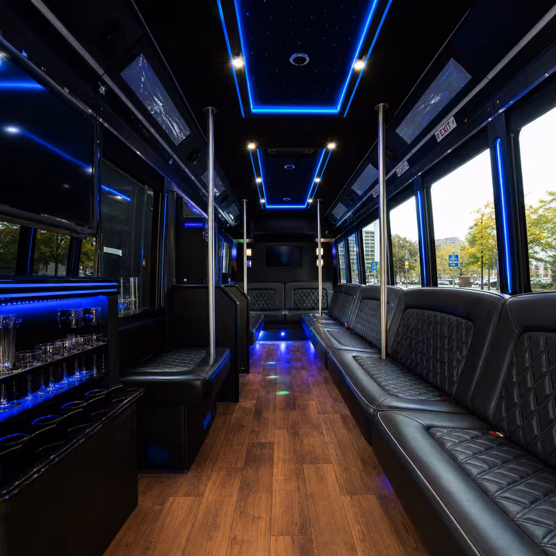 Party bus interior with wraparound leather seating and LED lighting in Seattle