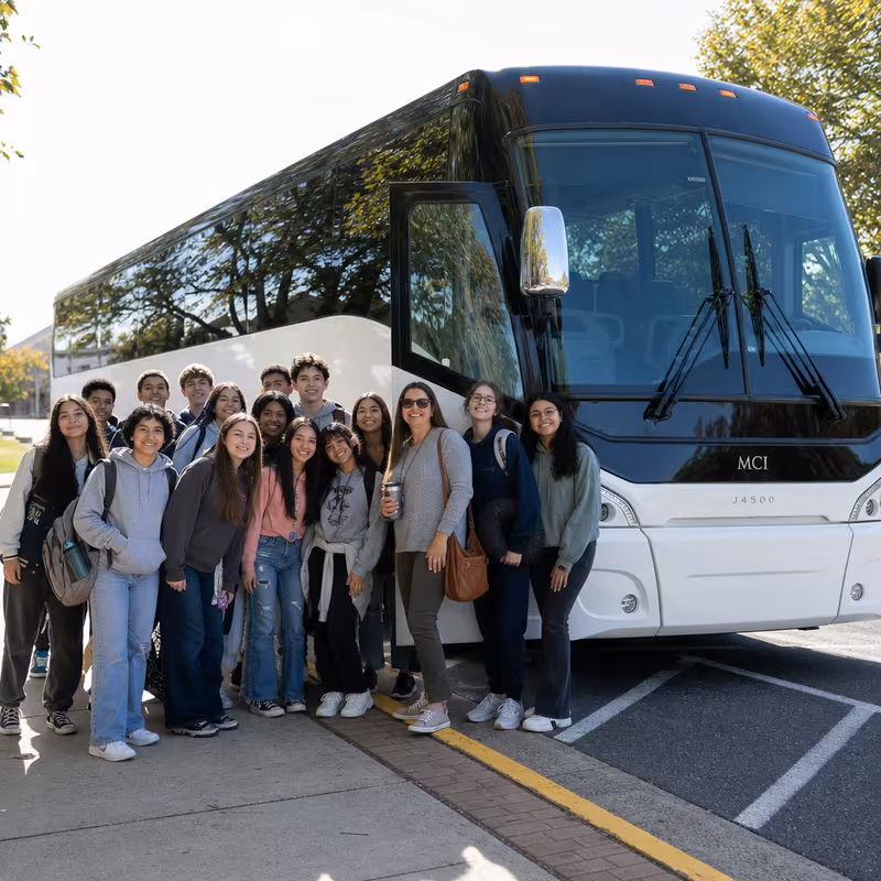 Passengers loading luggage while boarding an Seattle group shuttle