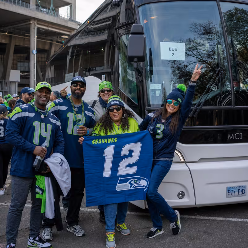 Passengers loading luggage while boarding an Seattle group shuttle