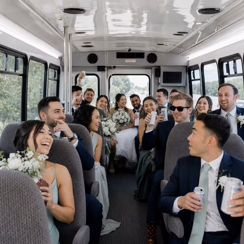 Group boarding a white charter bus for Wedding Transportation transportation in Seattle