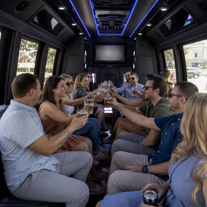 Group boarding a white charter bus for Winery & Brewery Tour Transportation transportation in Seattle