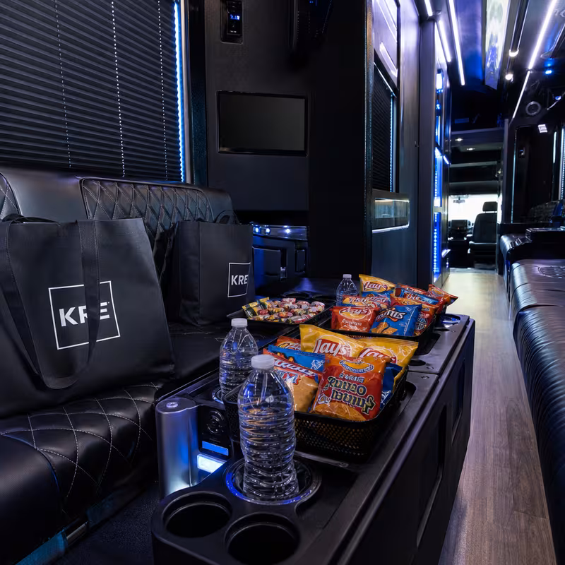 Party bus interior with wraparound leather seating and LED lighting in Seattle